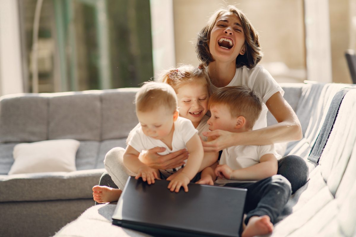 Happy mother with children sitting at home